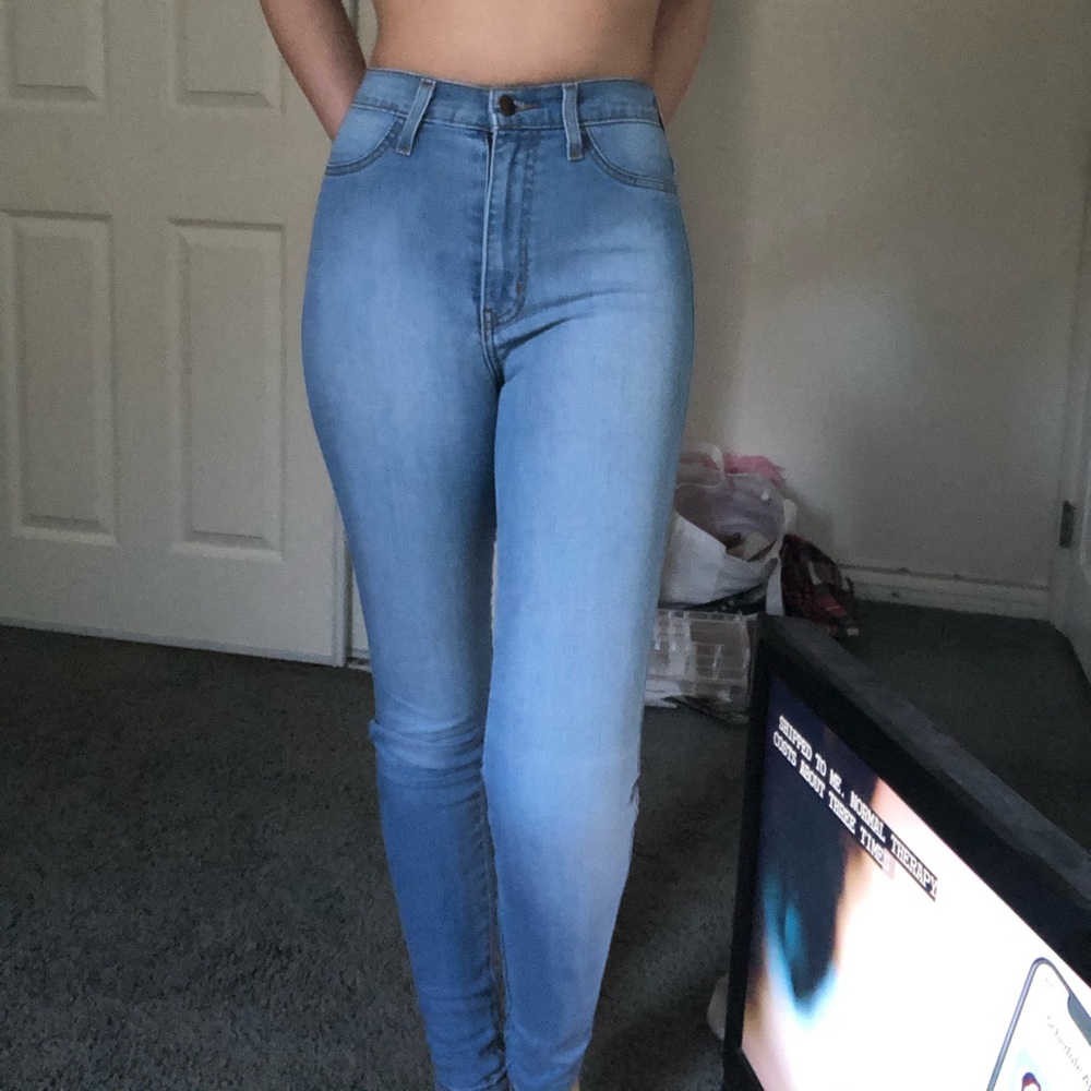 Extra high rise light wash denim jeans.